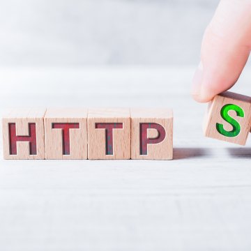 comodo ssl certificates benefits hand holding tiny wood block writing https